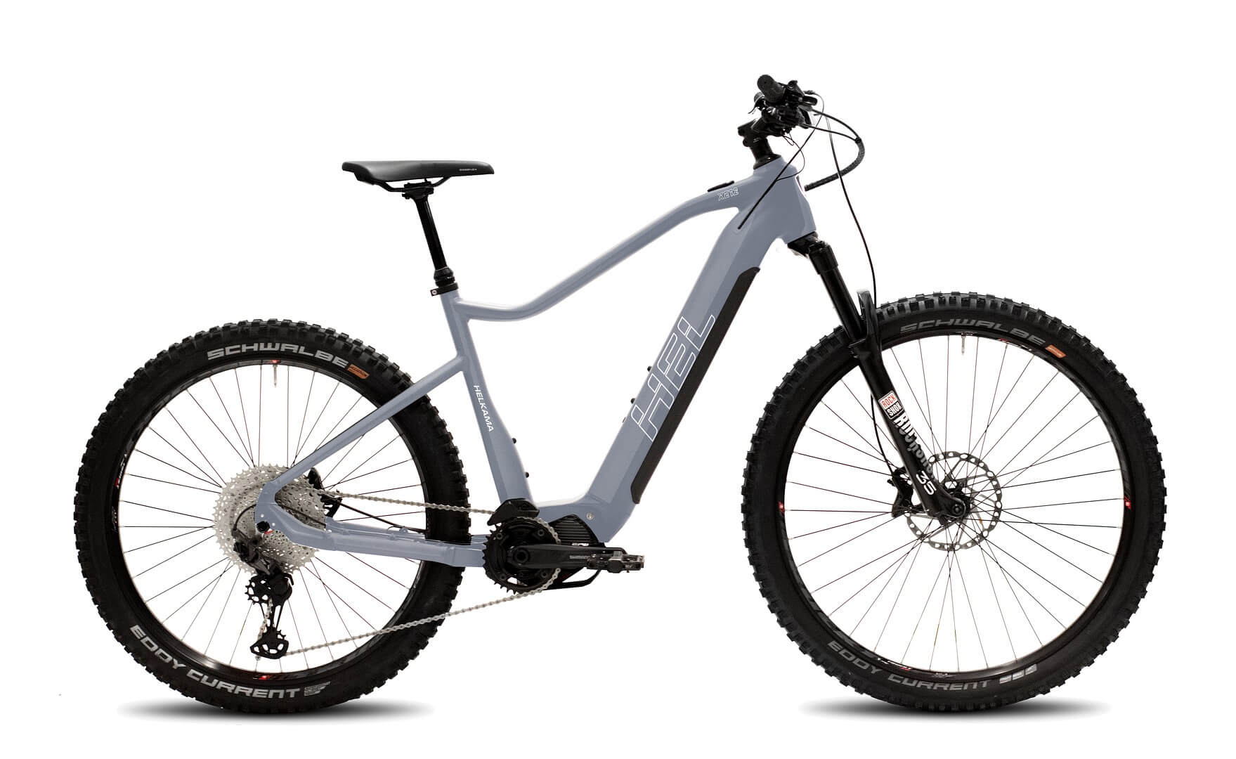Harmaa Helkama XE12 12v 29/27,5″ 708Wh sähköpyörä, jossa on paksut nastarenkaat, etujousitushaarukka, levyjarrut ja runkoon integroitu akku, näkyy sivulta valkoisella pohjalla.