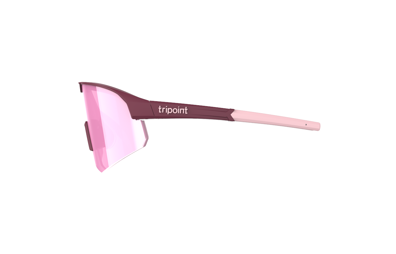 SÄHKÖPYÖRÄT.NETin Tripoint Mount Mist Small -urheiluaurinkolasien sivukuva, jossa on vaaleanpunaiset sävytetyt linssit, ruskeankeltainen ja vaaleanpunainen kehys, jossa on "tripoint" ohimossa, ja UV400-suojaus valkoisella pohjalla.