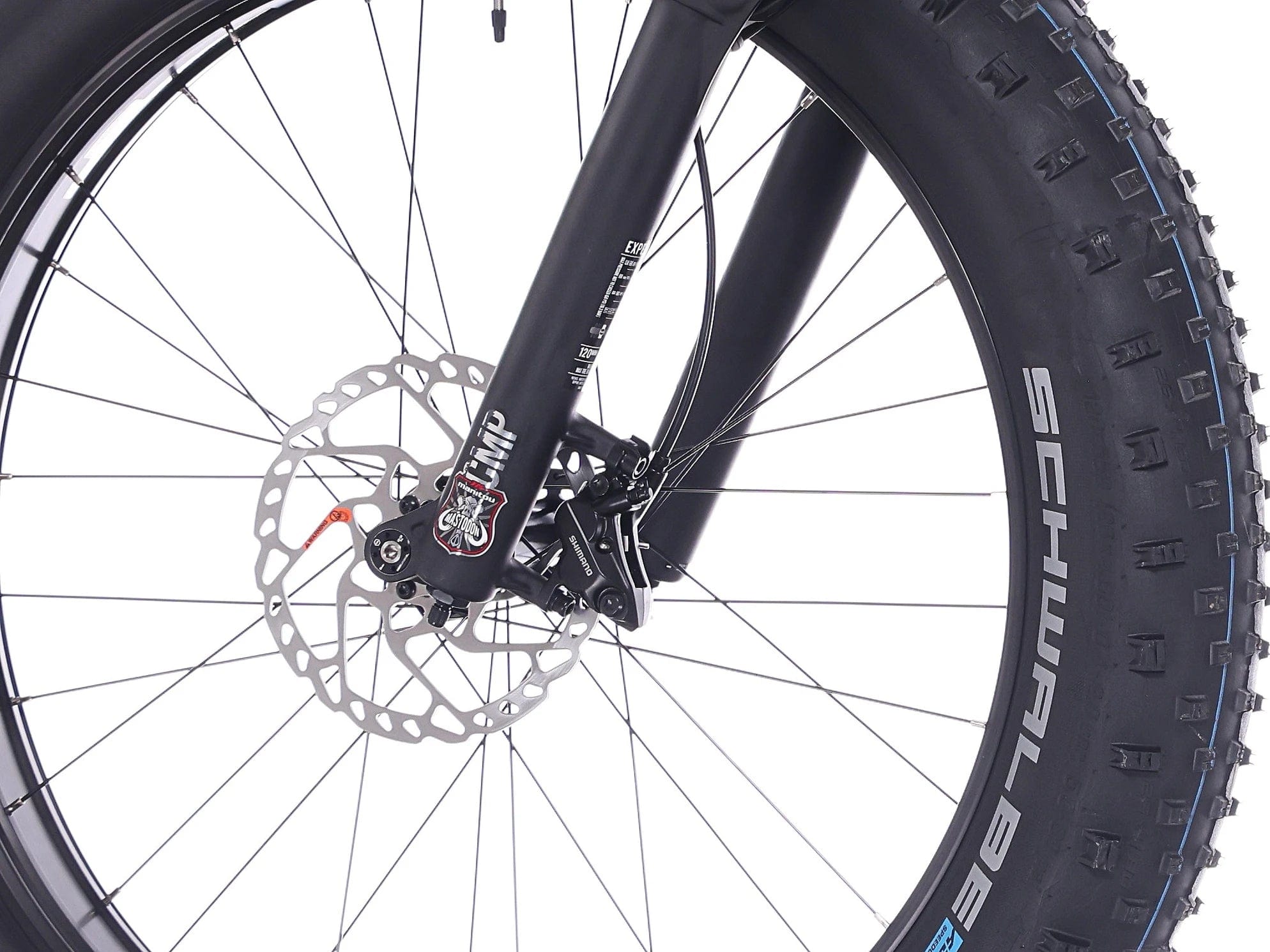 Lähikuva Rock Machine Vyöry E90 KEVÄTTARJOUS -etupyörästä, jossa on levyjarru, paksu Schwalbe-rengas, mustat pyörät ja merkkihaarukka. Sisältää Shimano EP6 -moottorin. Saatavana SÄHKÖPYÖRÄT.NETistä.