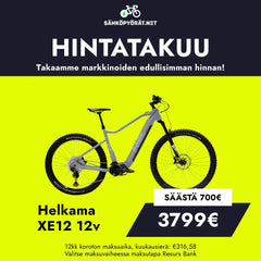 Harmaa-musta Helkama XE12 12v 29/27,5″ 708Wh sähköpyörä esillä keltaisella taustalla. Hinta 3799€, säästö 700€, hintatakuu suomeksi.
